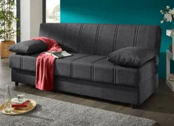 Frei im Raum aufstellbares Schlafsofa mit Dekokissen und Bettkasten